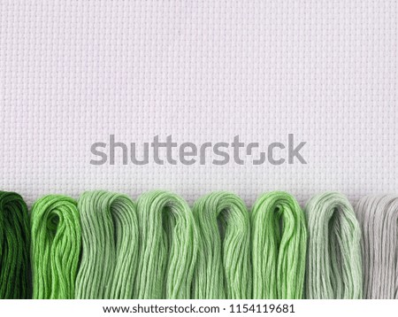 threads for embroidery on white canvas background