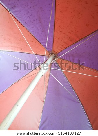 Red umbrella alternating with purple