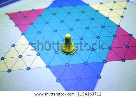 halma game board with yellow figure on it soft focus