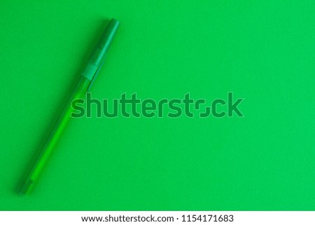 One  green pen on a background with place under text