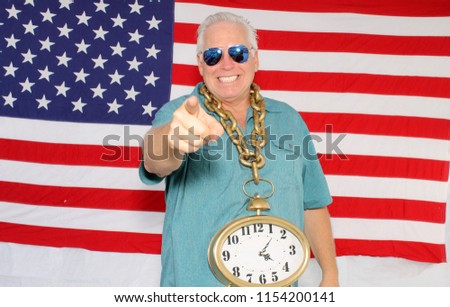 a man celebrates America in a Photo Booth. American Man in an American Flag Holiday Photo Booth. 