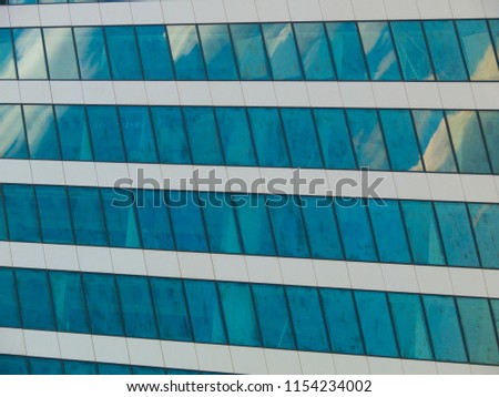 Square windows on blue house closeup photo. Place of work. Business office. Modern style architecture. Office building. Metallic building construction. Financial or business development concept image