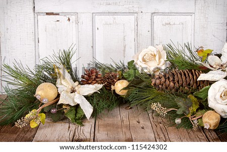 Christmas flowers and pine branches on wooden background