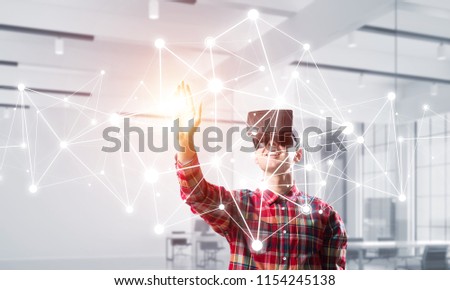 Young man with virtual reality headset or 3d glasses over connection background. Mixed media