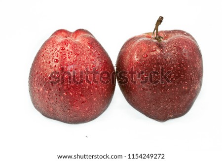 pair of wet red dark apples isolated on white