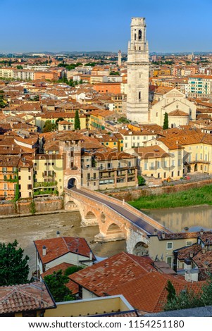 Summers morning skyline view of the famous historic quarter of Verona, Veneto, Italy, Europe. Taken from Castro San Pietro overlooking river Adige, Ponte Pietra bridge and Verona cathedral & tower. Royalty-Free Stock Photo #1154251180