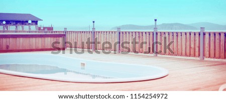 Banner Wooden deck beach sea ocean resort sun lounger umbrella hotel pool sky sunrise. Background for text copy space