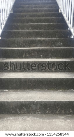 The stairs are made of gray concrete.