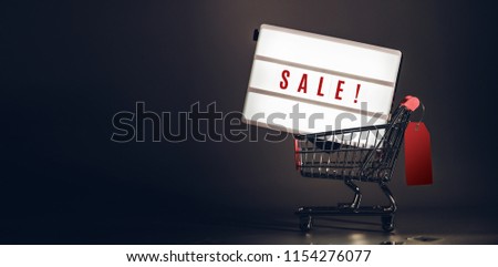 Sale light box in shopping cart with prize tag at dark studio room banner size.Mock up header leave space for adding text or design for promote business campaign on line