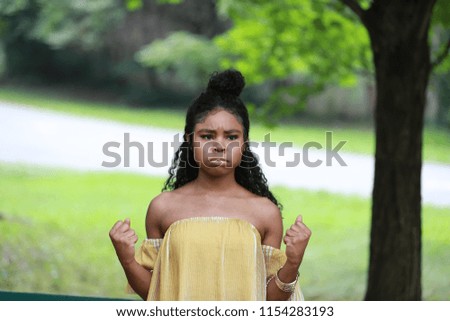 Young African American woman feeling offended and frustrated in green park 