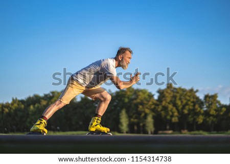 The old man rollerblading outdoor