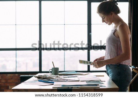 art painting inspiration creativity concept. woman looking at color swatches working on new project in her workshop.