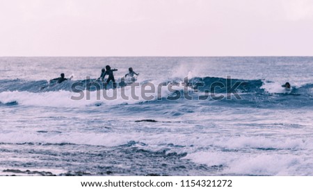 Young surfers takes the waves, vintage style photography.