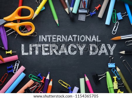 International Literacy Day. School Stationary Top View on Blackboard Royalty-Free Stock Photo #1154365705