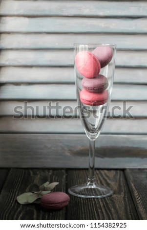 Group of macarons made of strawberries, cream, chocolate and blueberries. Rustic photo.