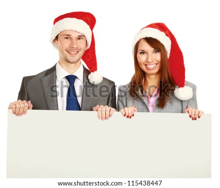 couple in santa hat holding a blank advertising placard