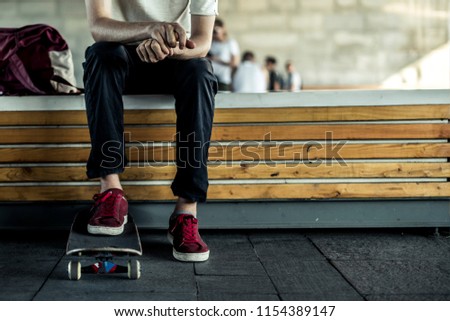 young classic skateboard rider close chilling in the street lifestyle photo