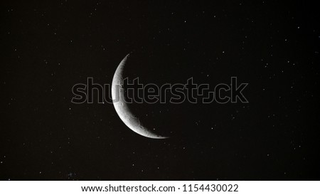Crescent Moon background / The Moon is an astronomical body that orbits planet Earth and is Earth's only permanent natural satellite. It is the fifth-largest natural satellite in the Solar System Royalty-Free Stock Photo #1154430022