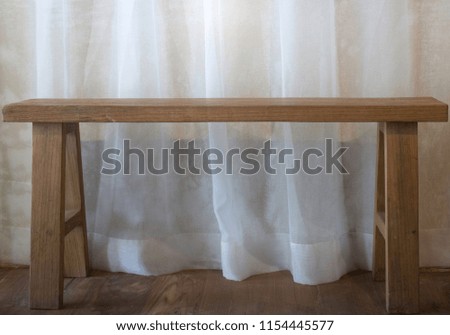 Warm cozy room with wooden bench, stock photo