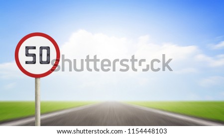 Traffic number 50 or Speed limit road sign on blurred asphalt road with colorful light background. Transport Concept
