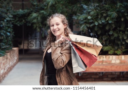 Young woman holding shopping bags, black friday, cyber monday sale