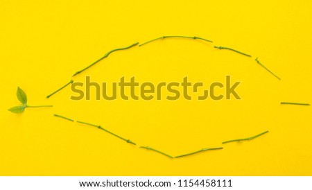 Leaf symbol fish on yellow background copyspace
