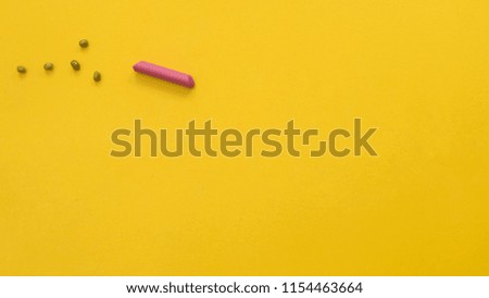 crayon symbol on yellow background