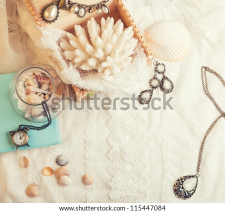 Vintage background with seashells, watch and jewelry. Romantic photo