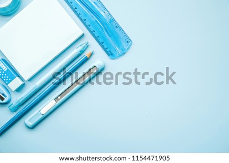 back to school concept. office supplies. blue stationery on blue background top view flat lay