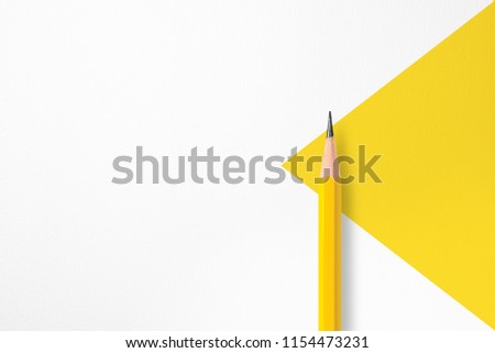 Minimalist template with copy space by top view close up macro photo of yellow pencil isolated on white textured paper and combine with yellow triangle. Flash light made smooth shadow from pencil. Royalty-Free Stock Photo #1154473231