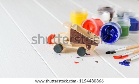 Application of colorful colored coating on the wooden model of the truck.