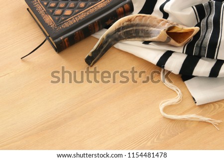 Prayer Shawl - Tallit, Prayer book and Shofar (horn) jewish religious symbols. Rosh hashanah (jewish New Year holiday), Shabbat and Yom kippur concept. Royalty-Free Stock Photo #1154481478