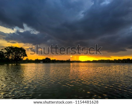 Soft focus to Storm clouds before the rain and colorful dramatic blue sky at sunset before storm in evening have reflection of Nong Prajak Public Park Ud onthani Thailand.Landscape Nature HDR Tone.