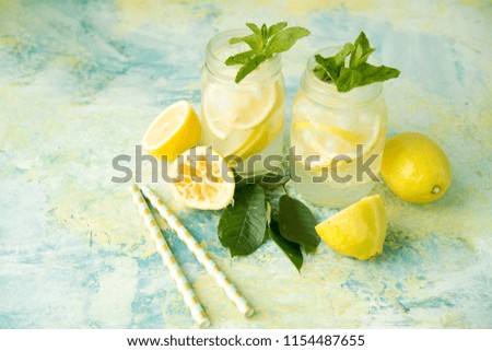 Homemade lemonade with lemons on a rustic background