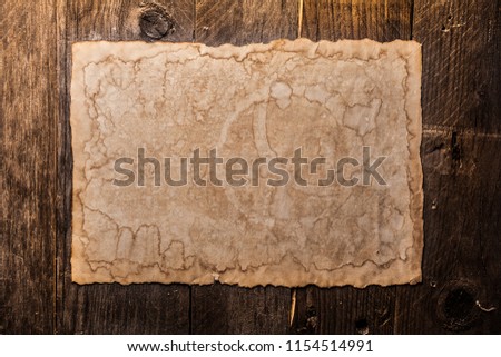 Vintage blank paper on a wooden background
