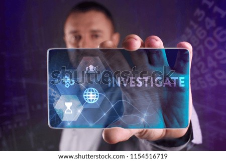 The concept of business, technology, the Internet and the network. A young entrepreneur working on a virtual screen of the future and sees the inscription: Investigate