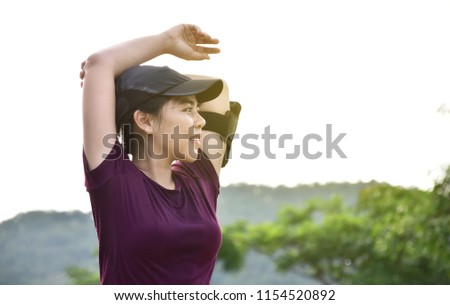 stretching muscle, young woman do exercise or yoga in the park, healthy lifestyle 
