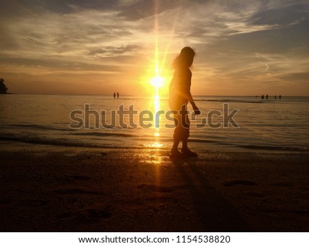 PICTURE OF YOUNG GIRL ENJOYING SUNSET AT PORT DICKSON BEACH MALAYSIA