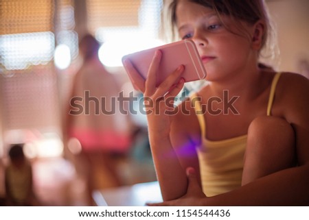 Little girl using smart phone. Copy space. Close up. 