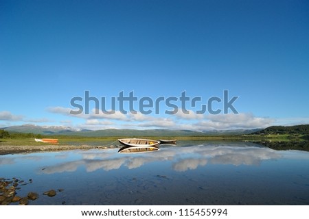 Wooden boats on the mountain lake