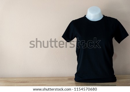 black T-Shirt isolated on a Pastel color background