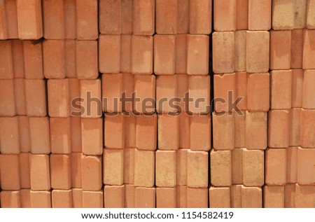 red bricks are stacked wall /pile of  orange bricks baked clay background