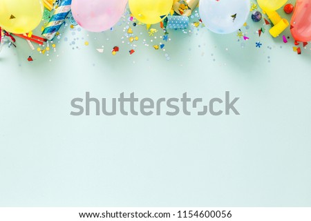 Flat lay decoration party concept on pastel blue background with border top view