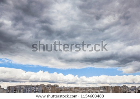Dramatic storm clouds over the city in summer afternoon
