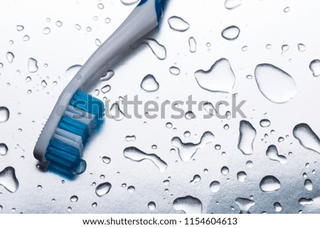 toothbrush on white background with drops of water. Close-up