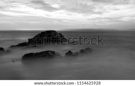 Long exposure of seascape scenery with rocks in black and white,beautiful image can be used nature composition for background and wallpaper