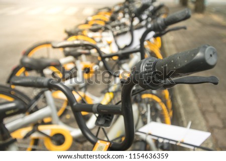 soft focus image of black handle 's bicycle parking near footpath