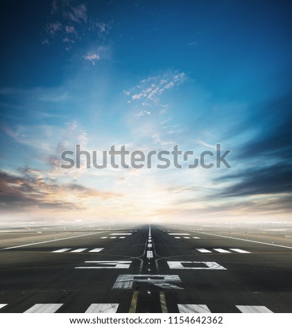 Empty asphalt airport runway with dramatic sky. Royalty-Free Stock Photo #1154642362