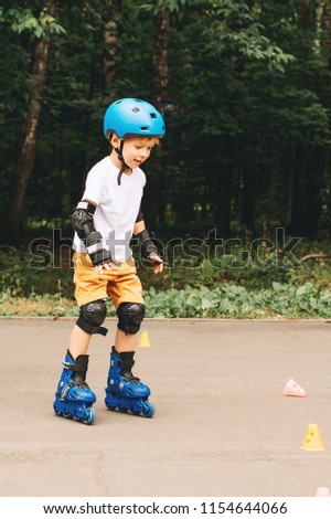 Boy riding on roller skates at outdoor park summer day