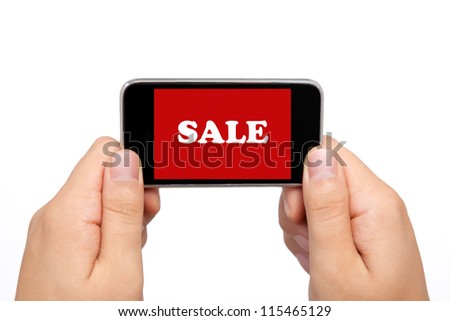 female hands holding a phone touch computer pad gadget with the word sale on a red screen
